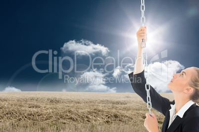 Composite image of businesswoman pulling a chain