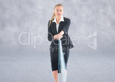 Composite image of businesswoman pulling a rope