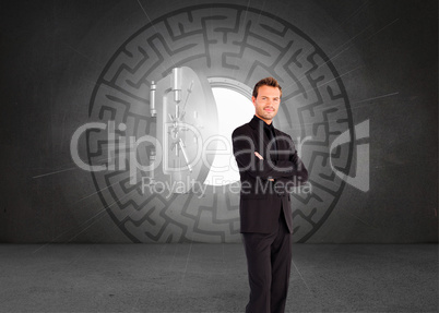 Composite image of handsome businessman with crossed arms