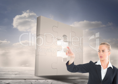 Composite image of businesswoman pointing somewhere