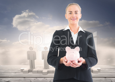 Composite image of businesswoman holding piggy bank