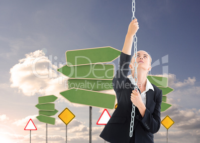 Composite image of businesswoman pulling a chain