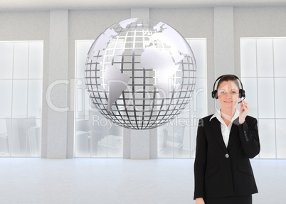 Composite image of good looking woman in suit using headphones a