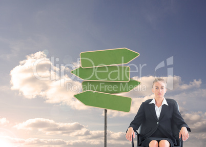 Composite image of businesswoman sitting on swivel chair in blac