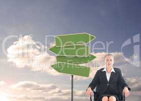 Composite image of businesswoman sitting on swivel chair in blac