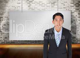 Composite image of serious asian businessman