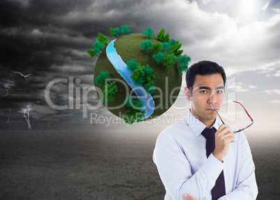 Composite image of unsmiling businessman holding glasses