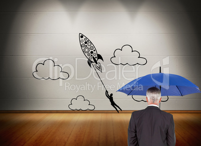 Composite image of businessman holding umbrella