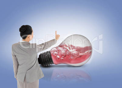 Composite image of asian businesswoman pointing