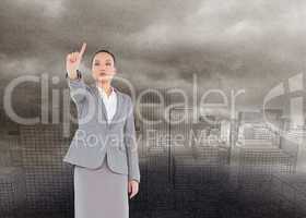 Composite image of unsmiling asian businesswoman pointing