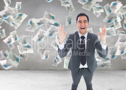 Composite image of excited businessman with arms raised