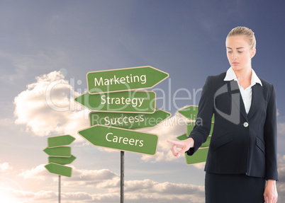 Composite image of businesswoman pointing somewhere