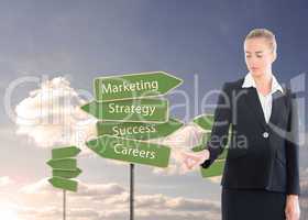 Composite image of businesswoman pointing somewhere