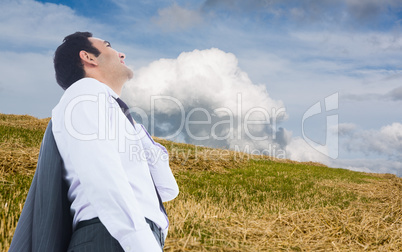 Composite image of smiling businessman standing