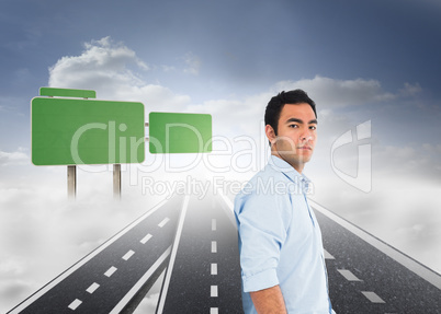 Composite image of unsmiling casual man standing