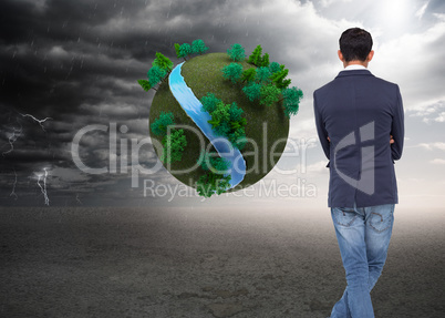Composite image of casual businessman with arms crossed