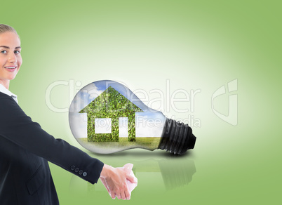 Composite image of businesswoman holding piggy bank