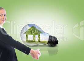 Composite image of businesswoman holding piggy bank