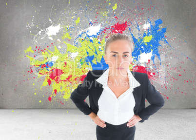 Composite image of businesswoman standing with hands on hips