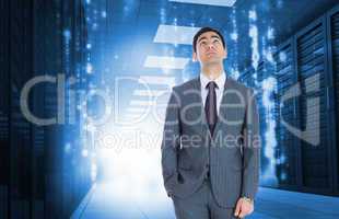 Composite image of unsmiling businessman standing