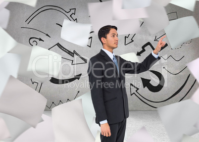 Composite image of serious asian businessman pointing