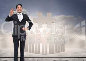 Composite image of smiling asian businessman pointing