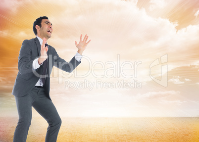 Composite image of screaming businessman catching