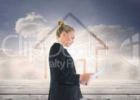 Composite image of businesswoman holding tablet