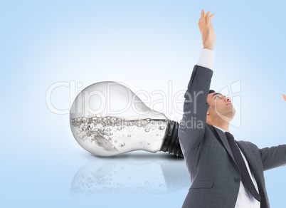 Composite image of unsmiling businessman with arms raised