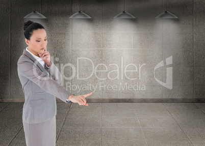 Composite image of unsmiling thinking asian businesswoman pointi