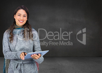 Composite image of smiling model wearing winter clothes holding