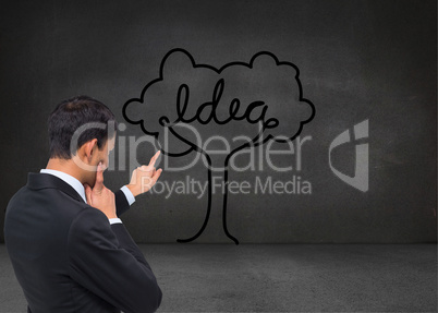 Composite image of thoughtful asian businessman pointing