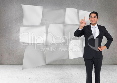 Composite image of smiling asian businessman pointing