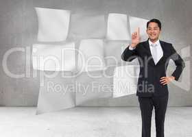 Composite image of smiling asian businessman pointing