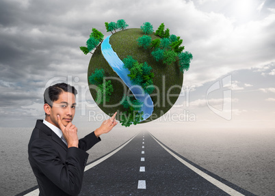 Composite image of thoughtful asian businessman pointing