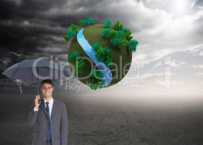 Composite image of happy businessman holding grey umbrella