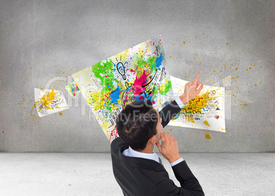 Composite image of thoughtful asian businessman pointing