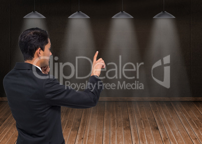 Composite image of thoughtful asian businessman pointing