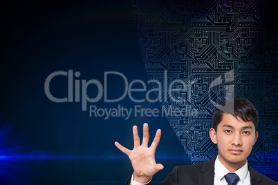 Composite image of unsmiling businessman holding and pointing