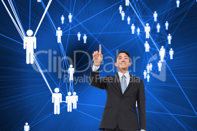 Composite image of smiling asian businessman pointing