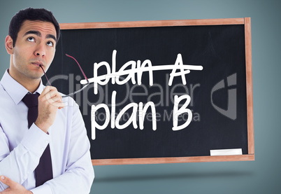 Composite image of thinking businessman holding glasses Composite image of thinking businessman holding glasses