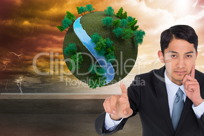 Composite image of thoughtful asian businessman pointing