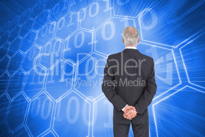 Composite image of rear view of serious businessman posing