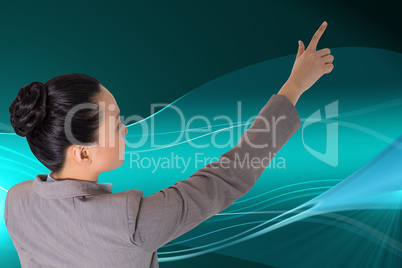 Composite image of unsmiling asian businesswoman pointing