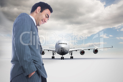 Composite image of smiling businessman standing