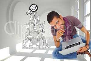 Composite image of thoughtful man sitting on floor using laptop