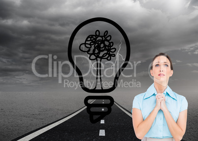 Composite image of troubled young businesswoman praying