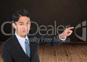 Composite image of unsmiling asian businessman pointing