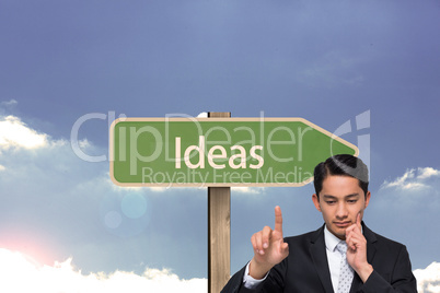 Composite image of thoughtful asian businessman pointing