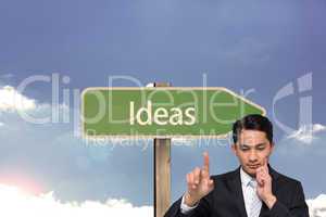 Composite image of thoughtful asian businessman pointing